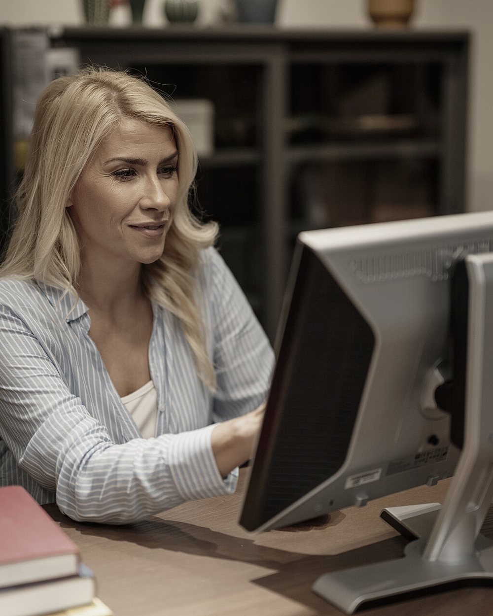 An inside-sales rep entering a quote at her desk.